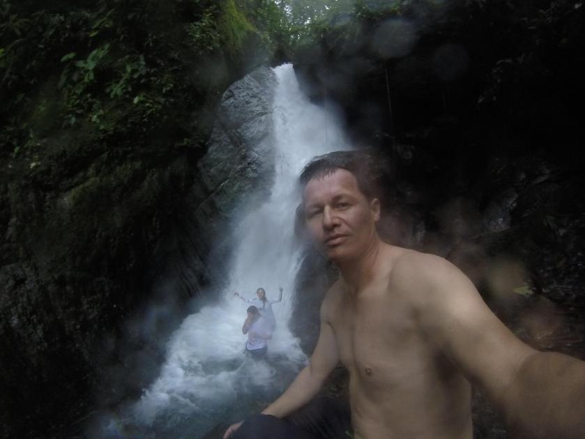 Friends under waterfall.